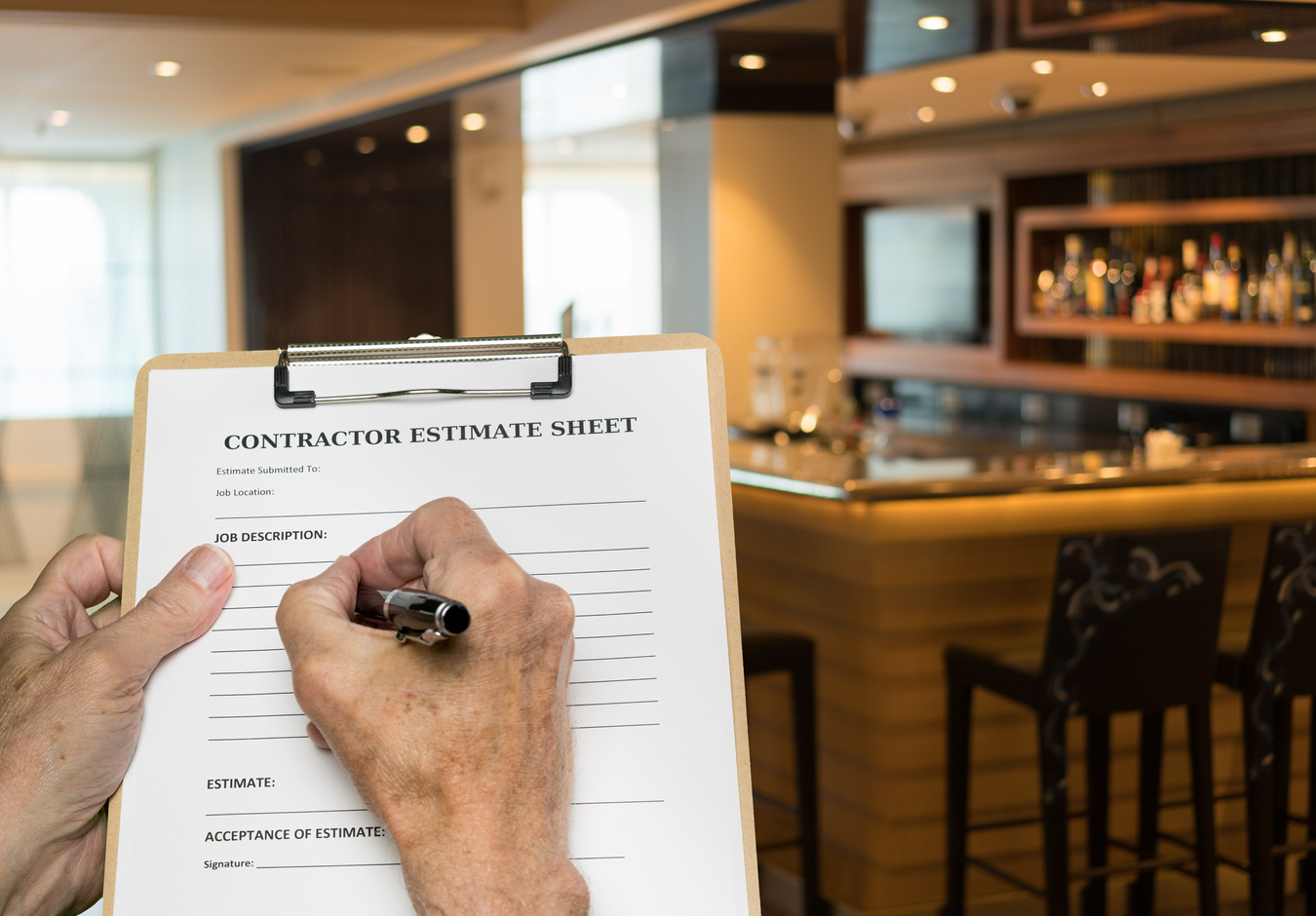 Contractor Filling Out Estimate for Refitting Modern Bar